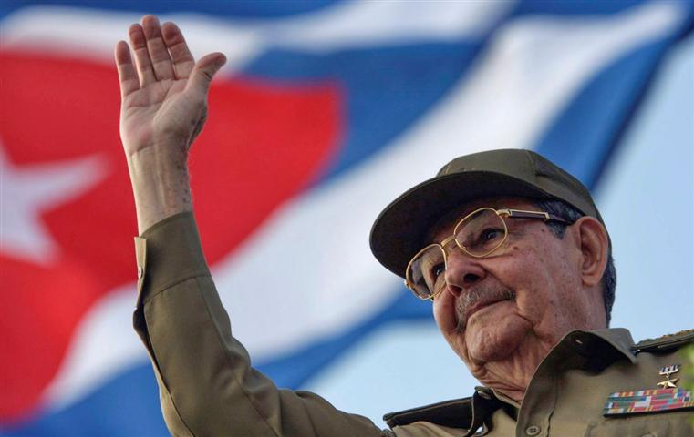 Raúl Castro ante Bandera de Cuba saludando